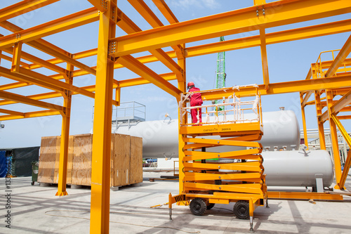 Yellow steel construction in open at factory.
