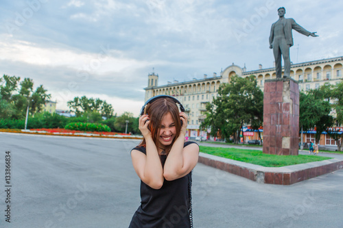 Asian girl listening to music with headphones photo