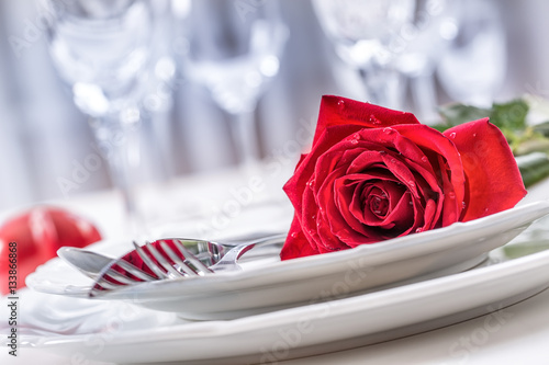 Table setting for valentines or wedding day with red roses. Romantic table se...