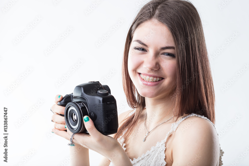 young woman in braces and a reflex camera young woman in braces and a reflex camera