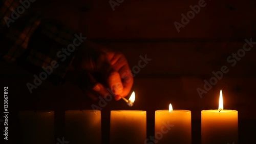 This is a video of five candles with flames at the bottom of the frame leaving lots of space for copy on a blank retro ship wood background