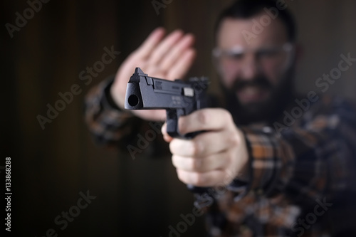 man with put on protective goggles and ear training in pistol sh