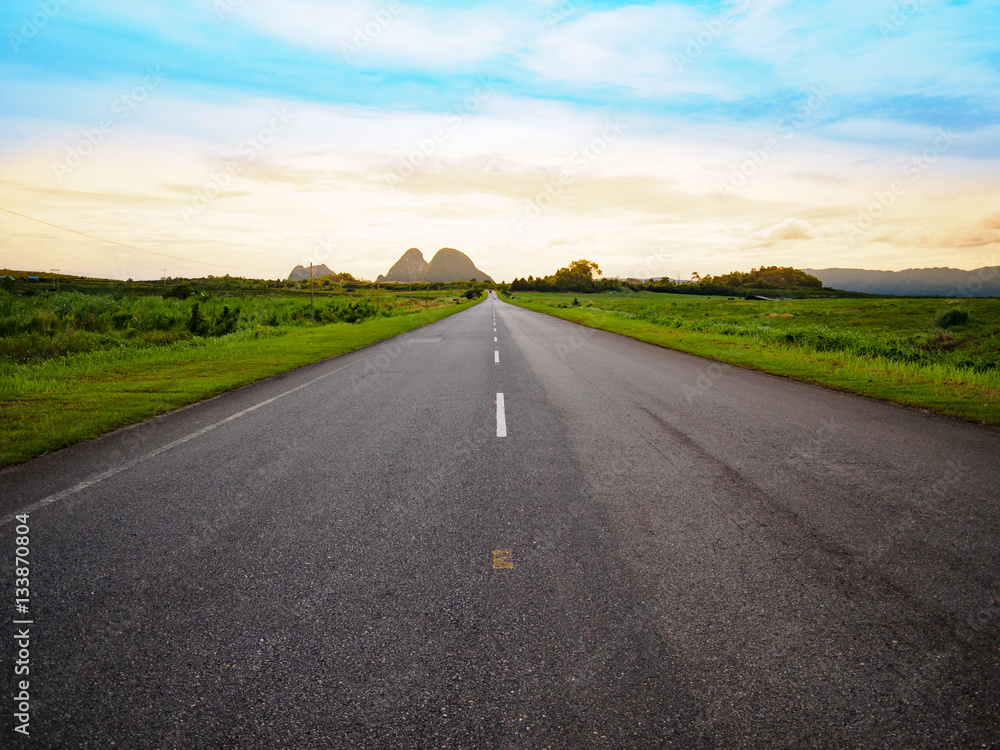 asphalt road with yellow blue sky background during sunset asphalt road with yellow blue sky background during sunset