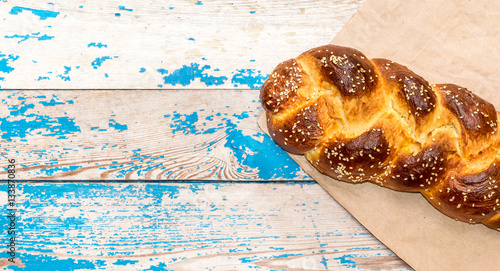 Sweet bun on old blue wooden background. photo