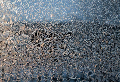 glittering frosty pattern on glass closeup