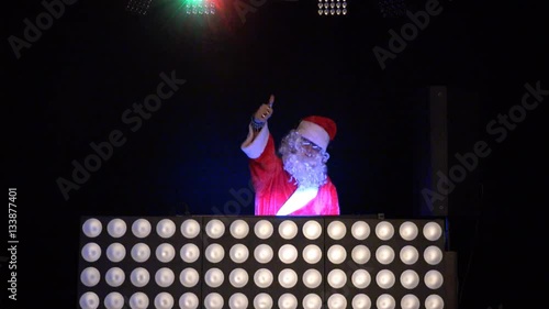 Dj Santa Claus for Christmas in the rays of light, music