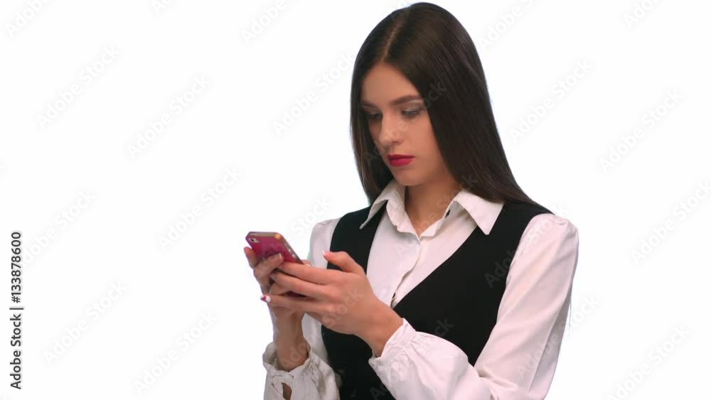 Young woman writing sms on mobile phone at isolated background Young woman writing sms on mobile phone at isolated background