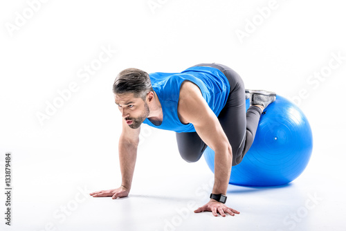 Man exercising on fit ball photo