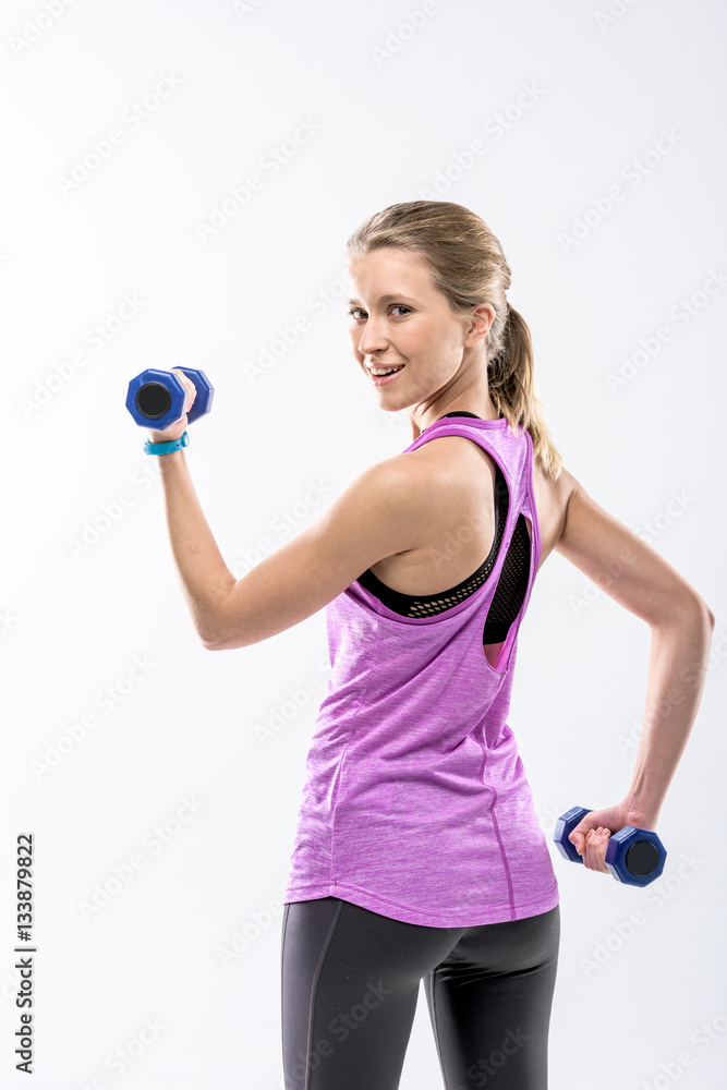 Woman exercising with dumbbells Woman exercising with dumbbells