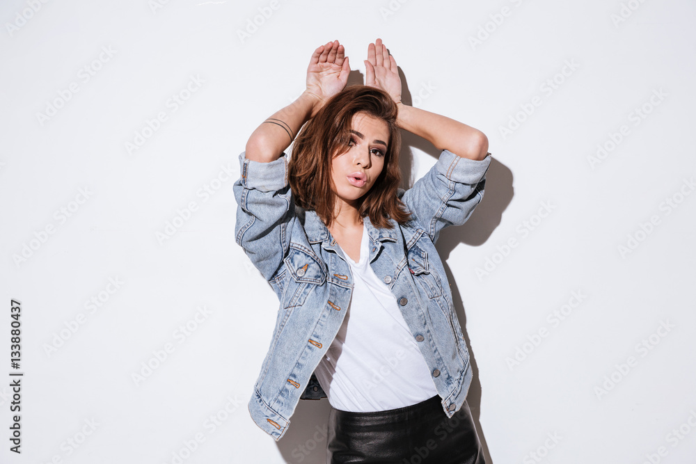 Funny woman showing bunny ears with hands. Funny woman showing bunny ears with hands.
