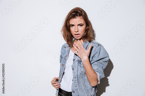 Young attractive woman isolated over white background.