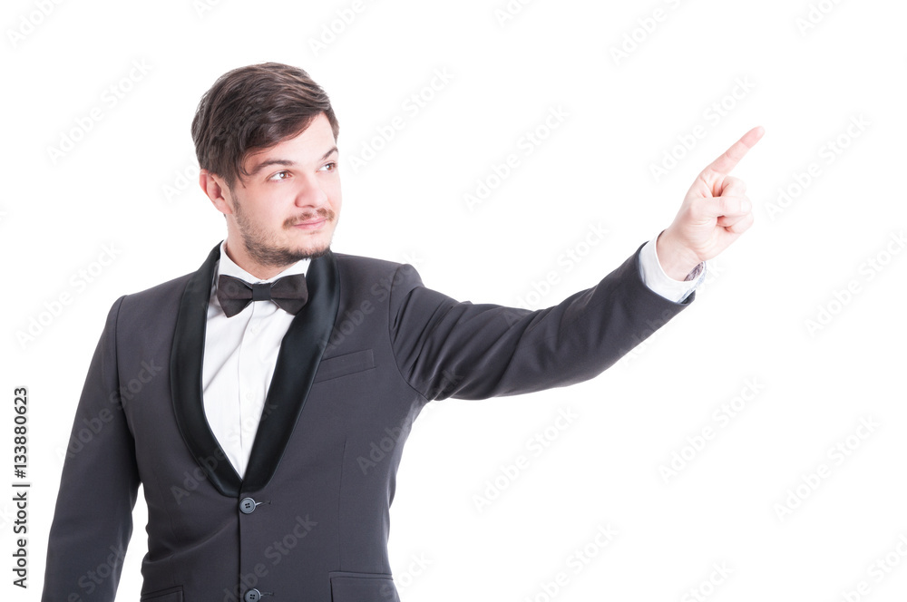Handsome man wearing tuxedo and bowtie pointing Handsome man wearing tuxedo and bowtie pointing