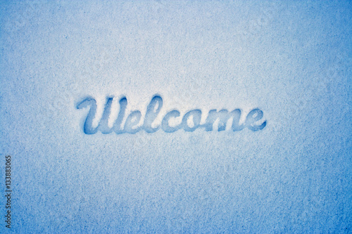 Welcome message imprint in the snow. Winter landscape.