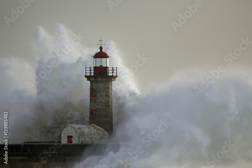 Stormy wave over lighthouse