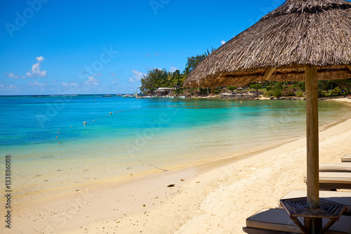 Fototapeta Naklejka Na Ścianę i Meble -  White sand beach with lounge chairs and umbrellas in Mauritius I