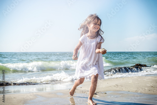 Fotografie Happy little girl on the beach