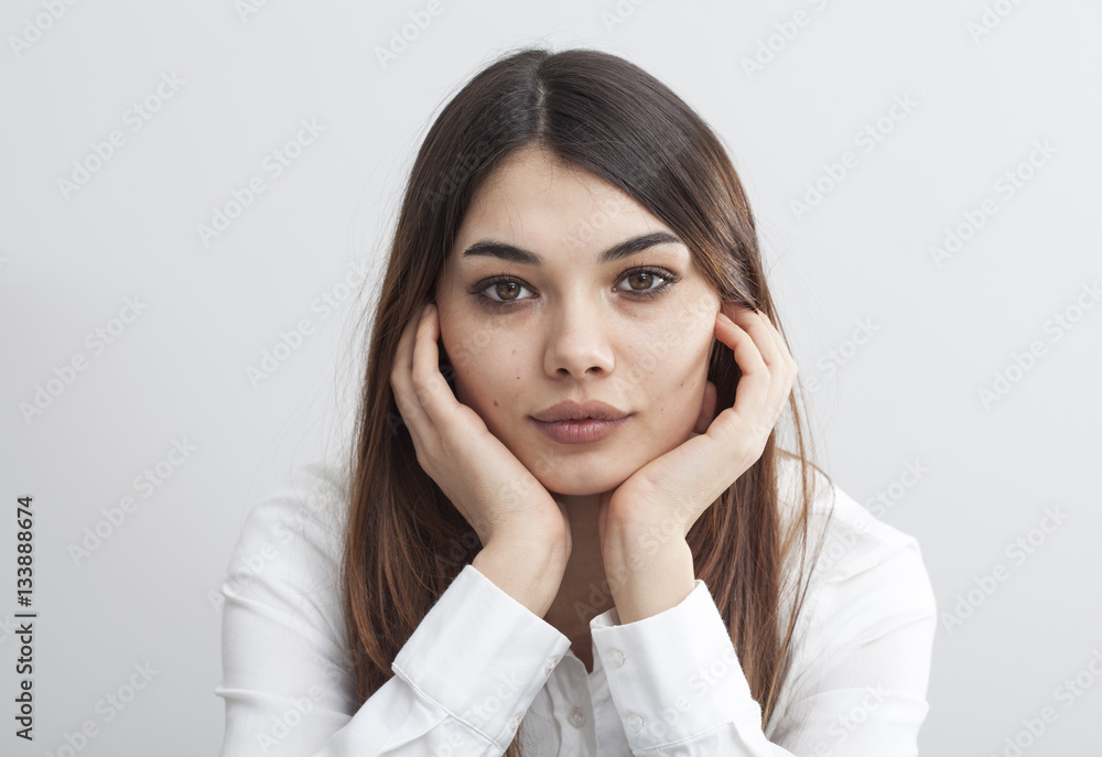 Portrait of young woman on gray background