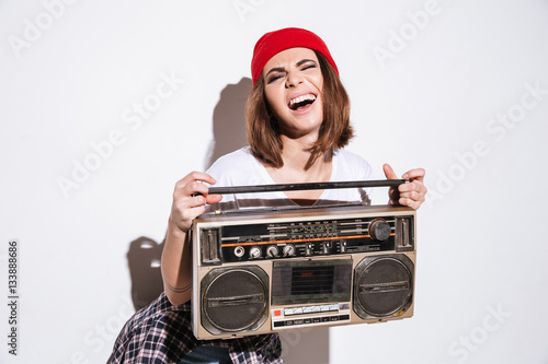 Young pretty lady holding tape recorder.