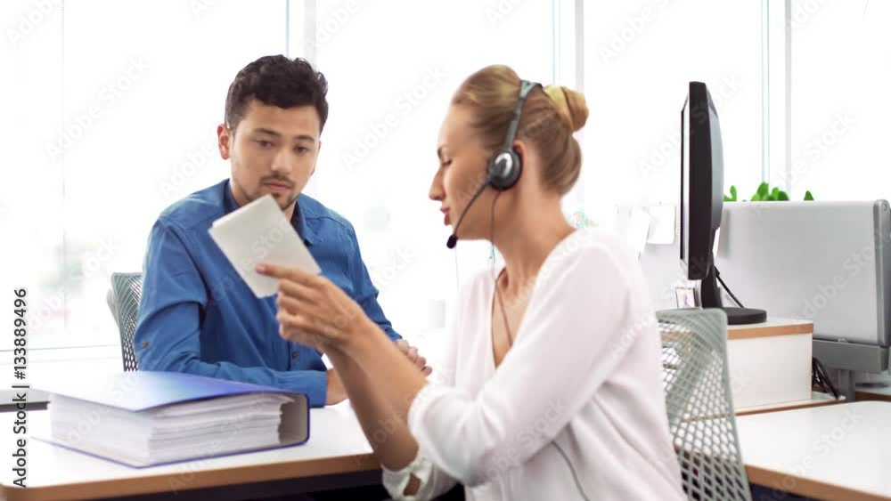 Colleagues working at modern office, man explaining to woman questions Colleagues working at modern office, man explaining to woman questions