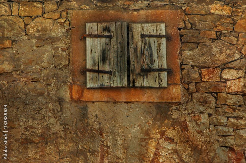 Worn wooden window in a village in Croatia Worn wooden window in a village in Croatia