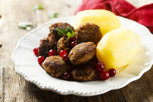 Meatballs with boiled potatoes and berries photo