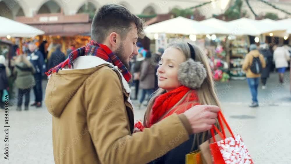 Lovely couple holding christmas presents and smiling to the camera, steadycam shot
Lovely couple holding christmas presents and smiling to the camera, steadycam shot