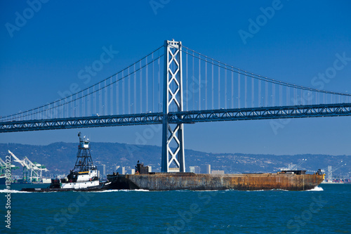 boat crossing under Oakland bridge © Nuaestudio