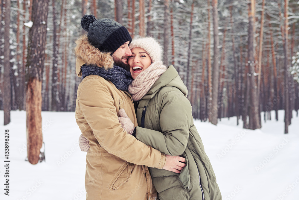 Affectionate couple enjoying spending time together in a snowy f