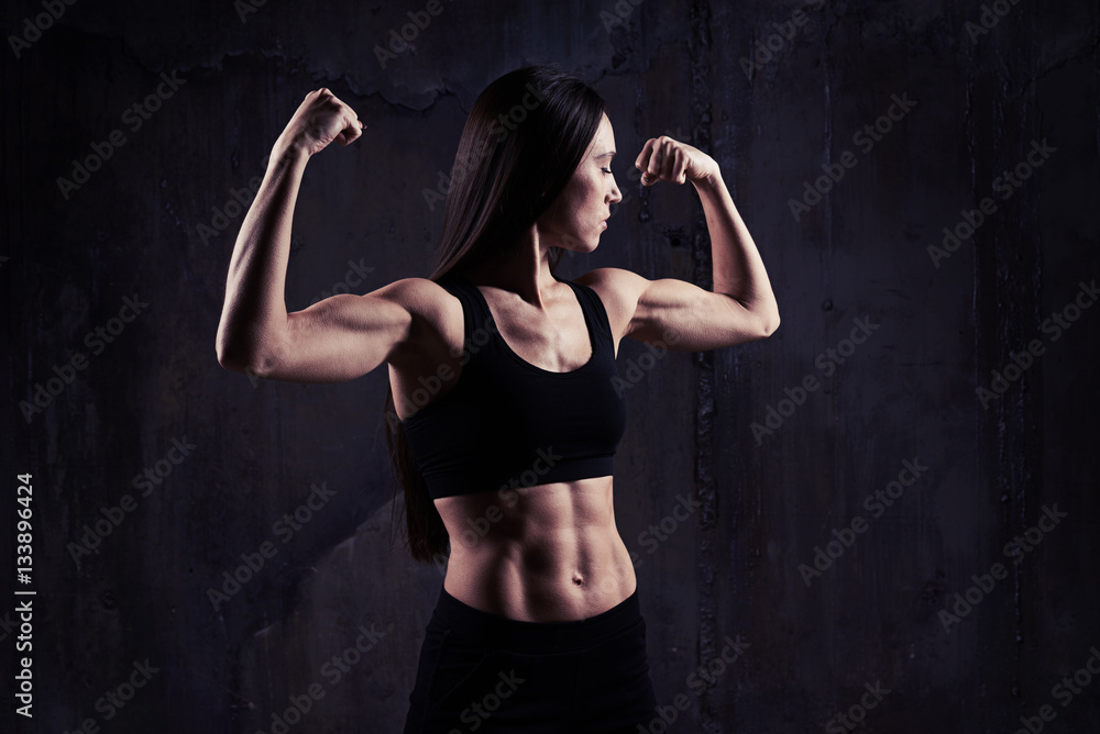 Close-up shot of woman flexing muscles showing great relief of a Close-up shot of woman flexing muscles showing great relief of a