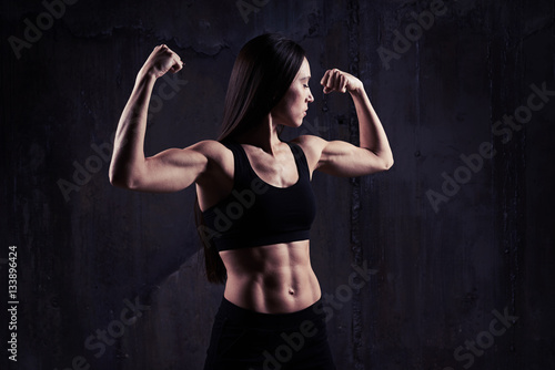 Close-up shot of woman flexing muscles showing great relief of a © ArtFamily