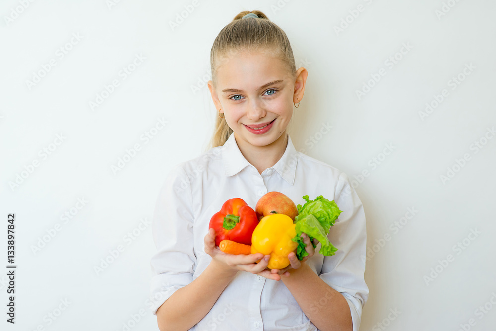 Happy fitness girl holding vegetables isolated Happy fitness girl holding vegetables isolated