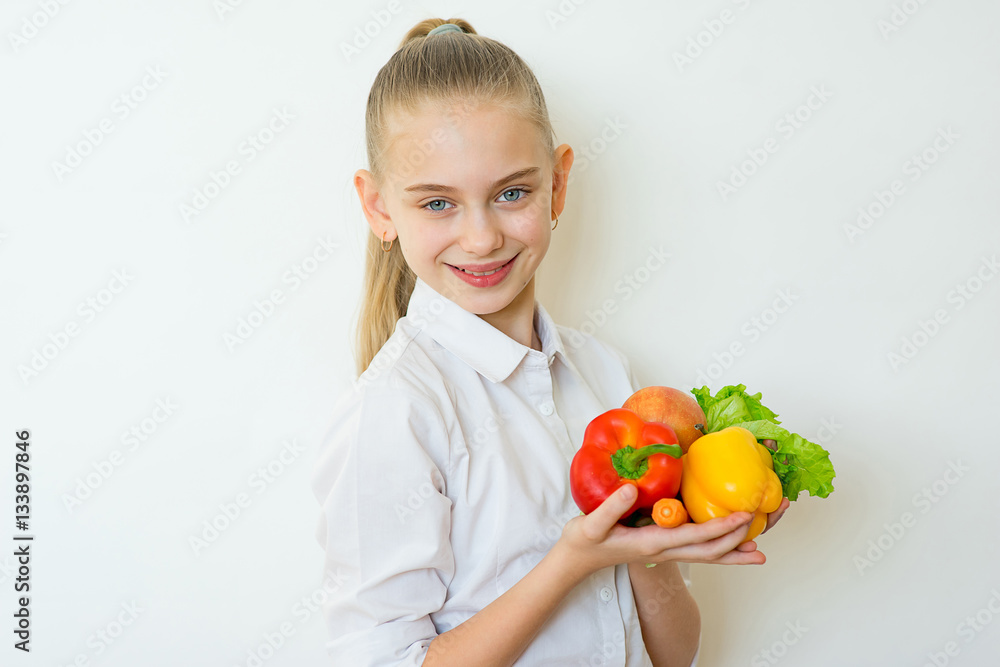 Happy fitness girl holding vegetables isolated Happy fitness girl holding vegetables isolated
