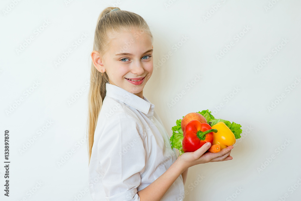 Happy fitness girl holding vegetables isolated Happy fitness girl holding vegetables isolated