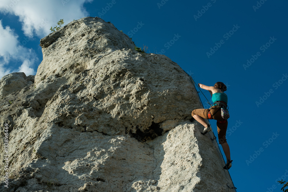 Woman is climbing on a vertical wall, Poland