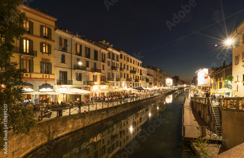 View of canal waterfront in Navigli district at night, Milan, Italy photo