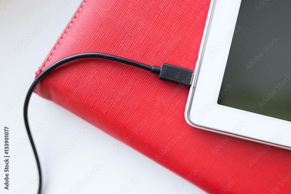 Close-up plugging in USB charging or data cable Close-up plugging in USB charging or data cable