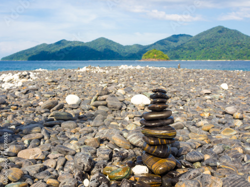 Bild auf Leinwand Balance stone on sea beach mountain background