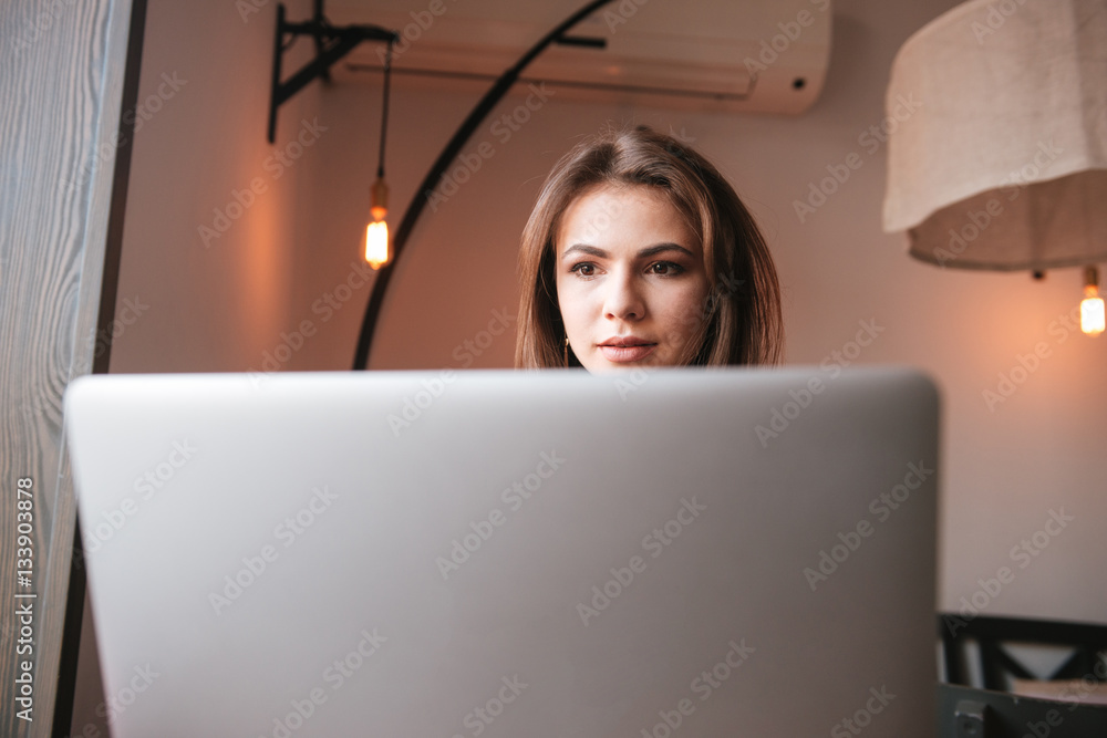 Pretty young woman look at laptop. Pretty young woman look at laptop.