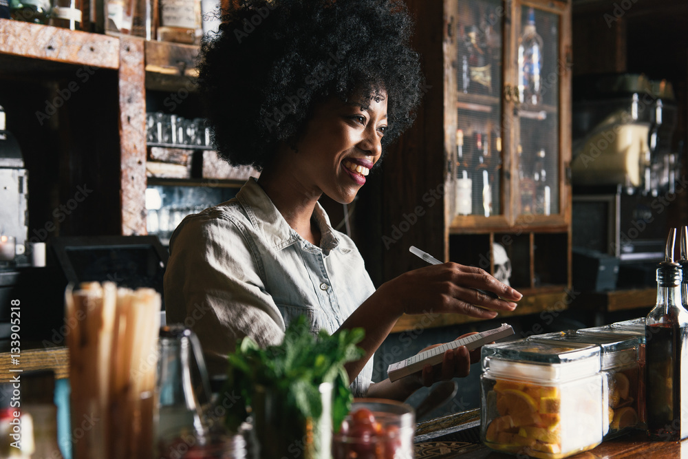 Bartender working behind bar in pub Stock Photo Adobe Stock