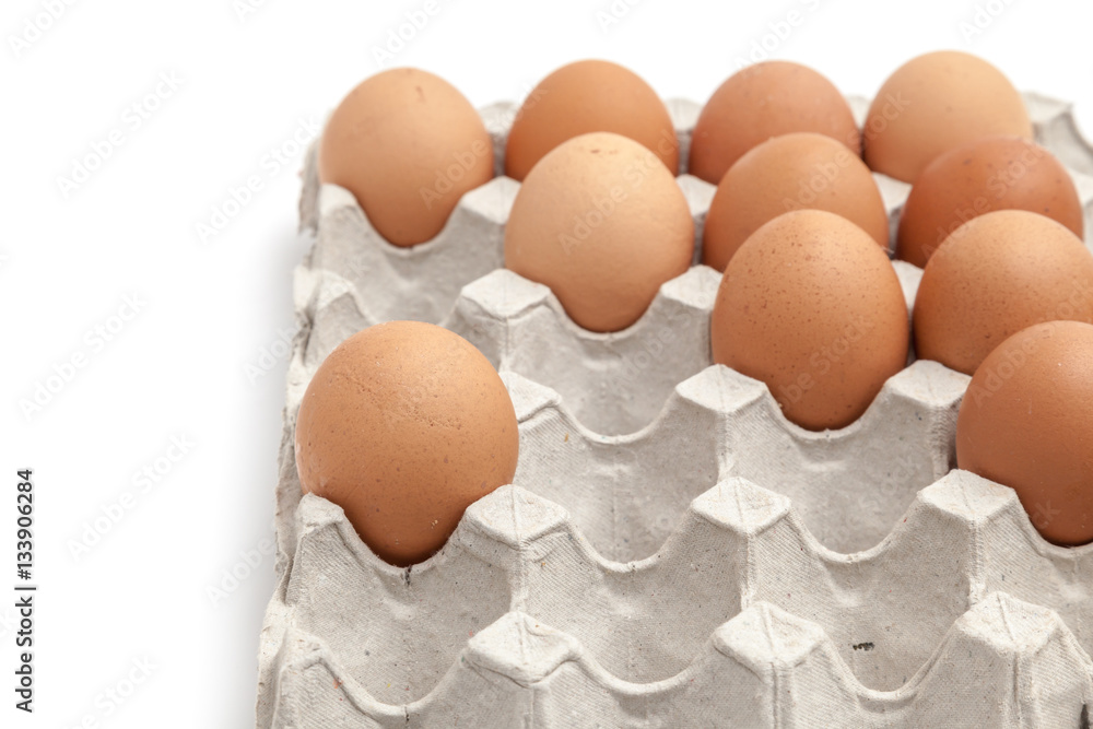 Eggs in paper egg tray on white background isolated