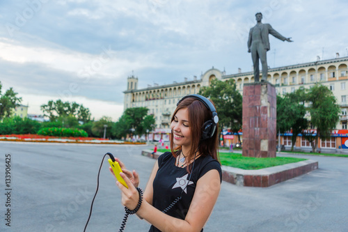 Asian girl listening to music with headphones photo