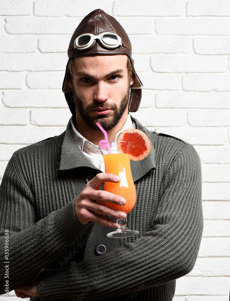 Fototapeta premium bearded pilot with cocktail in glass