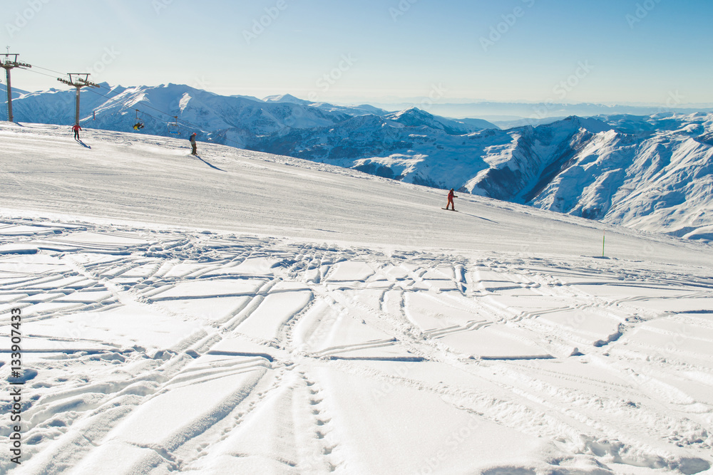 Ski run with amazing view on Caucasus Mountain range. Skiing resort. Extreme sport. Active holiday. Free time, travel concept. Copy space