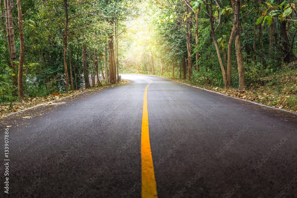 Rural road with a curve and sunlight at Mae Ya Waterfall, Doi Inthanon, Chiang Mai Thailand. Rural road with a curve and sunlight at Mae Ya Waterfall, Doi Inthanon, Chiang Mai Thailand.