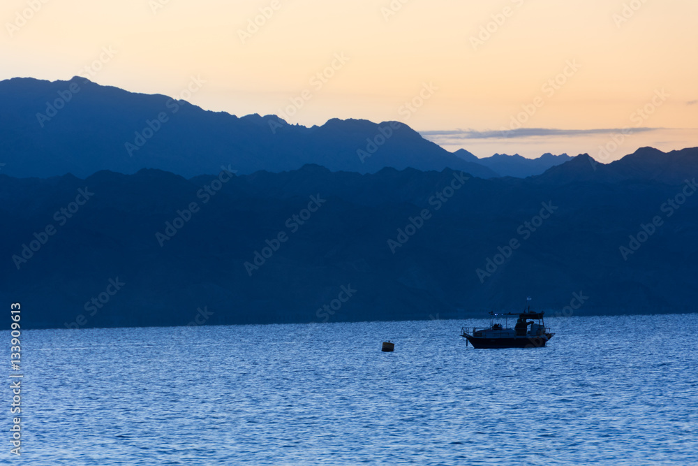 Boat at sunrise in Gulf of Aqaba Boat at sunrise in Gulf of Aqaba