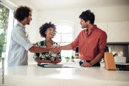 Real estate agent with couple buying new house