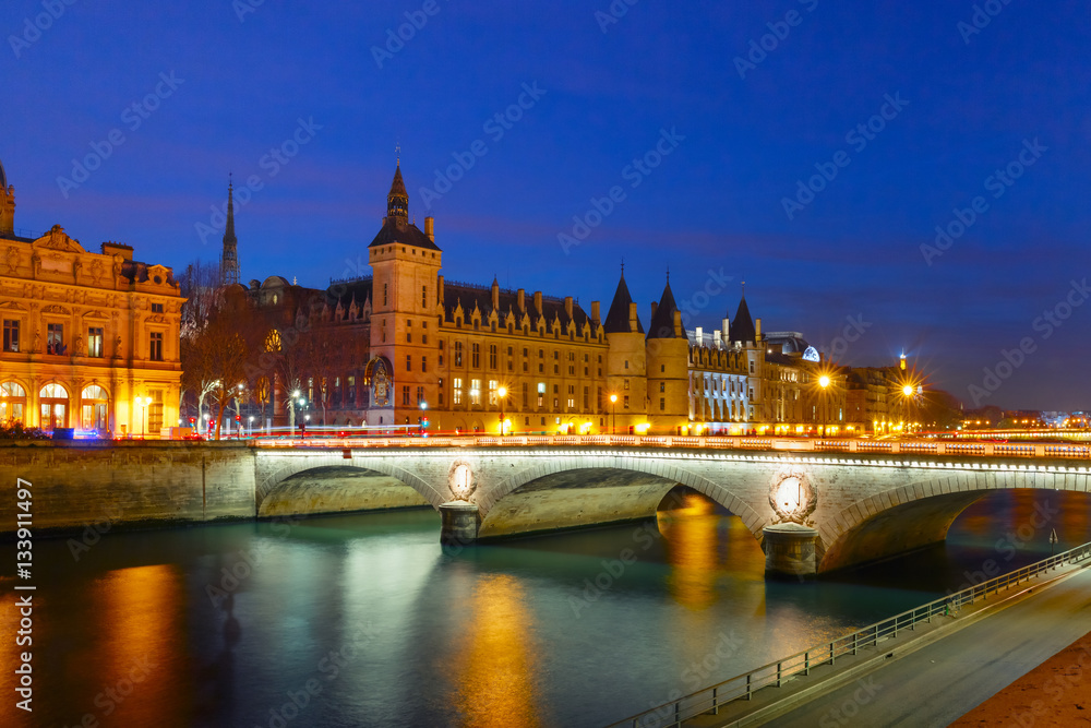 Conciergerie and Illuminated bridge Pont au Change at night, Paris, France