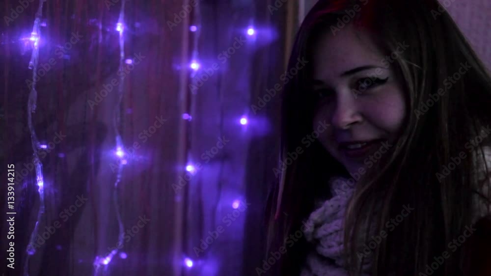 young attractive girl standing near lights wall young attractive girl standing near lights wall