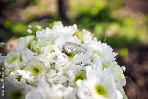 Fototapeta Naklejka Na Ścianę i Meble -  Wedding rings on bridal bouquet