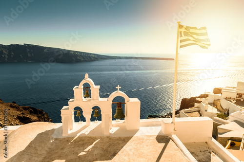 Top of orthodox church with greece flag in Santorini